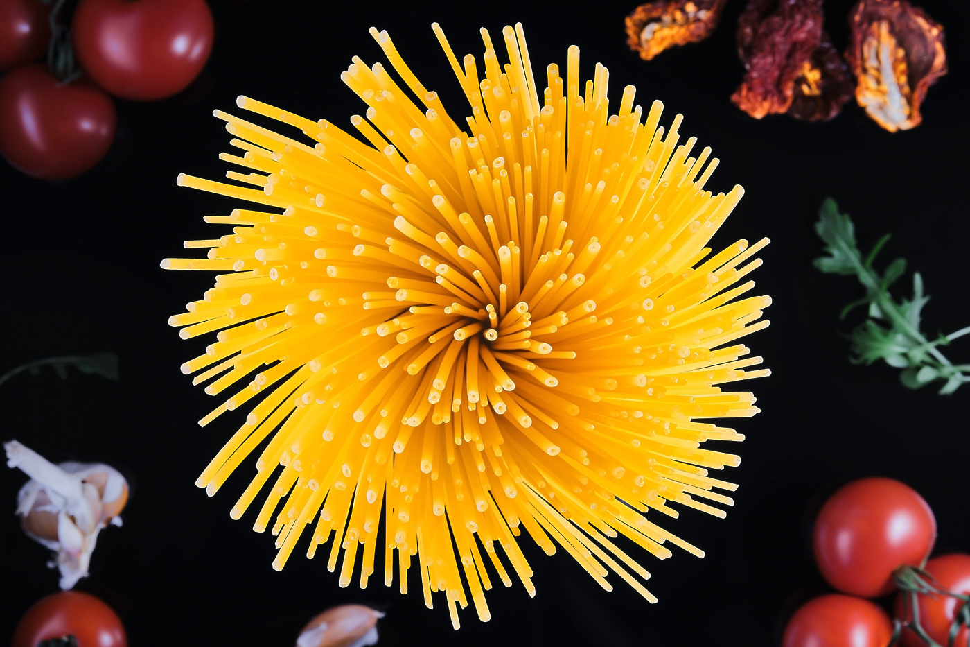 svetovnidantesteninraw whole grain italian pasta tomatoes ingredients cooking dish dark background sheaf spaghetti closeup